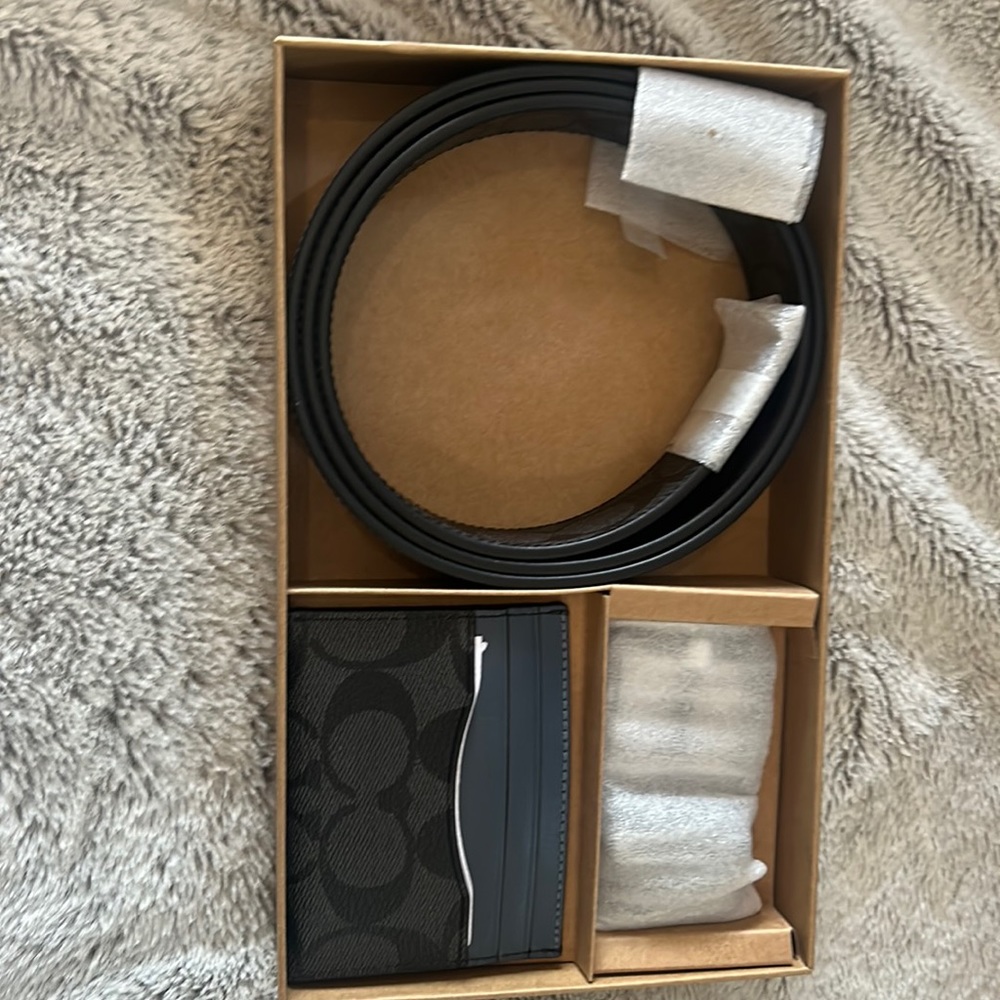 It’s a navy blue coach belt with a mini wallet